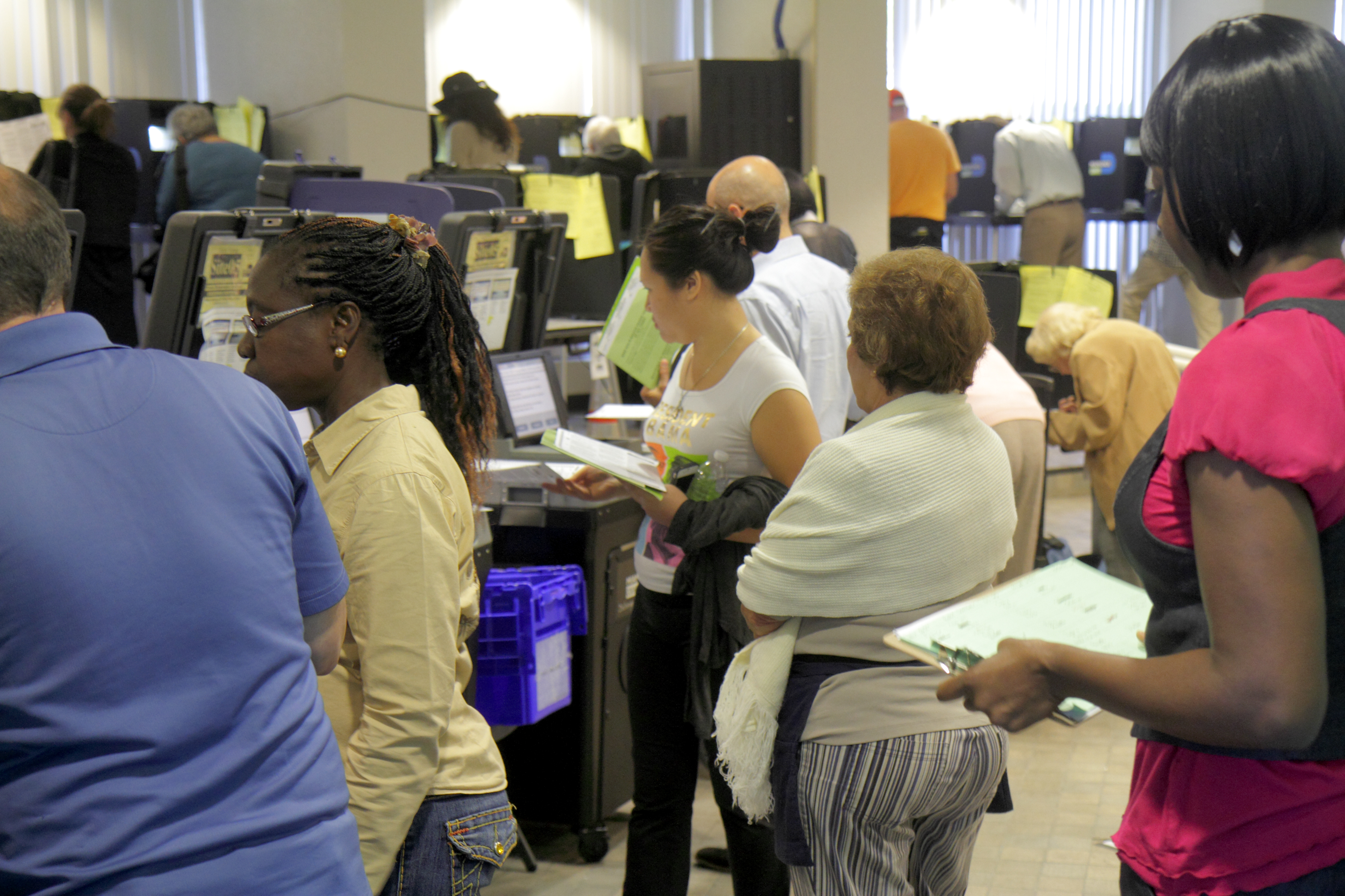People waiting to use the voting machines in City Hall at Miami Beach.