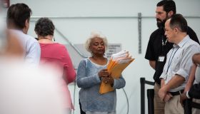 Brenda Snipes, Supervisor of Elections seen leading the hand...