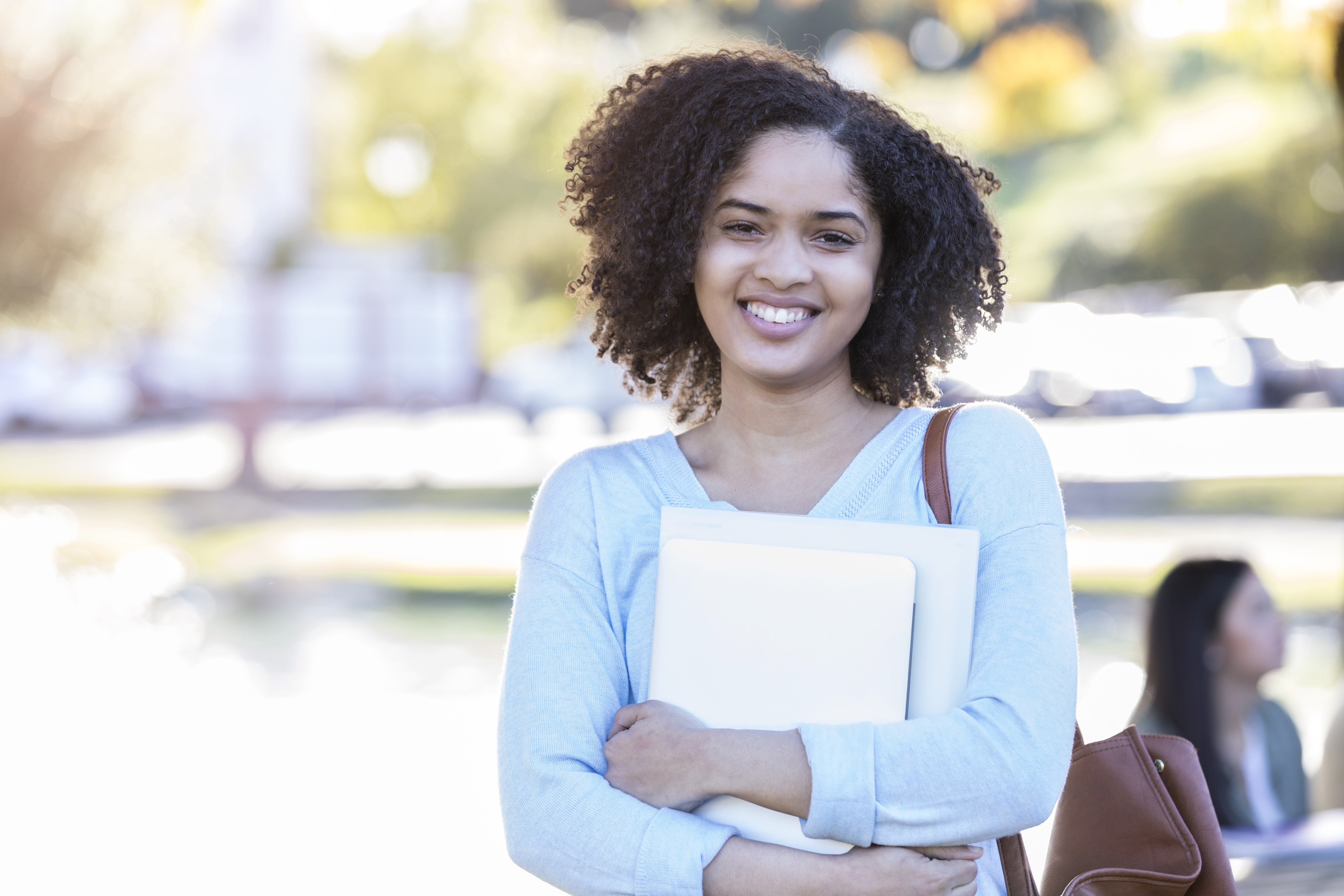 Portrait of young female college student standing on campus