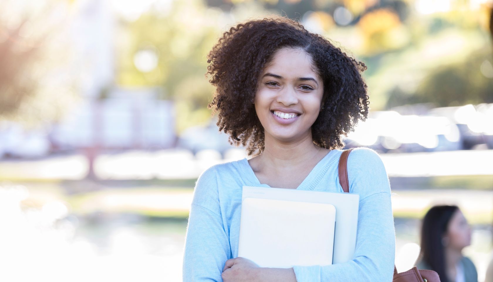 Portrait of young female college student standing on campus