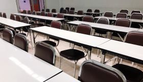 Empty Chairs Arranged At Tables In Lecture Hall