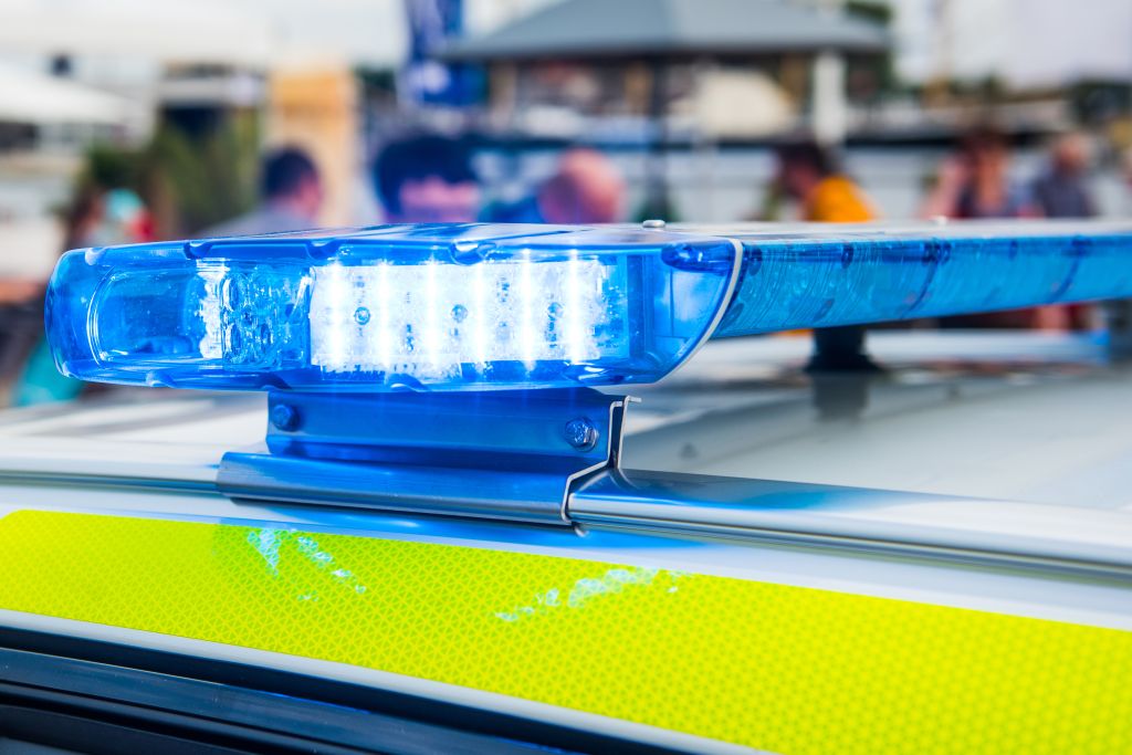 Close-Up Of Blue Emergency Light On Police Car Roof