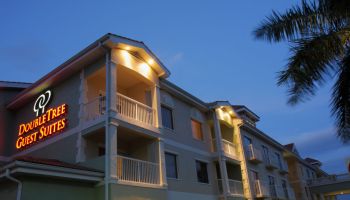 The exterior of Hilton Doubletree Guest Suites at night