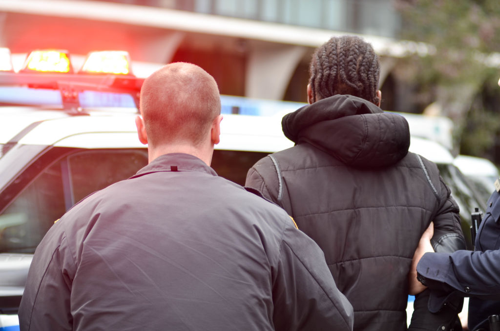 NYPD officers are seen arresting a bike messenger for...
