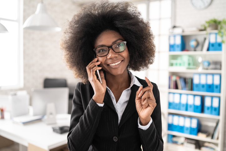 African bussinesswoman talking on smart phone at work