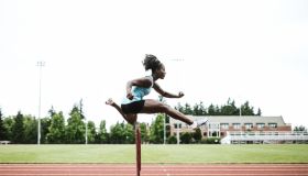Woman Athlete Runs Hurdles for Track and Field