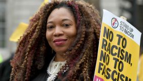 A protester seen holding a placard that says no to racism,...