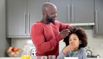 Dad fixes daughter's hair