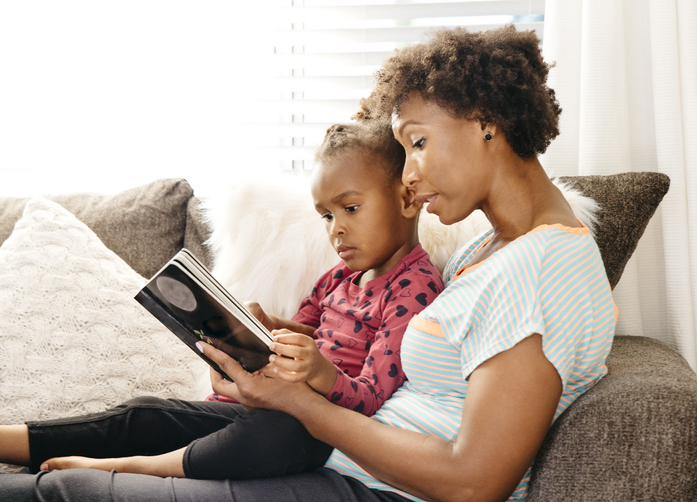 Mother reading to daughter