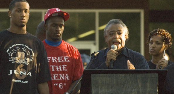Reverend Al Sharpton (2nd-R) speaks with