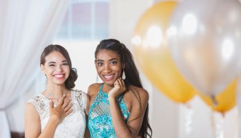 Two multi-ethnic teenage girls dressed for special event
