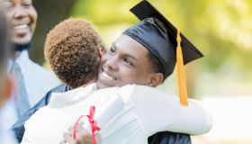 Proud mom hugs her son after graduation