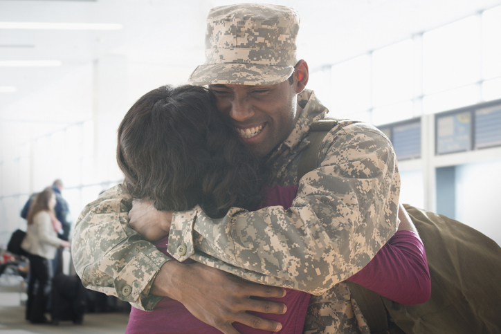 Returning soldier hugging wife