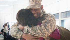 Returning soldier hugging wife
