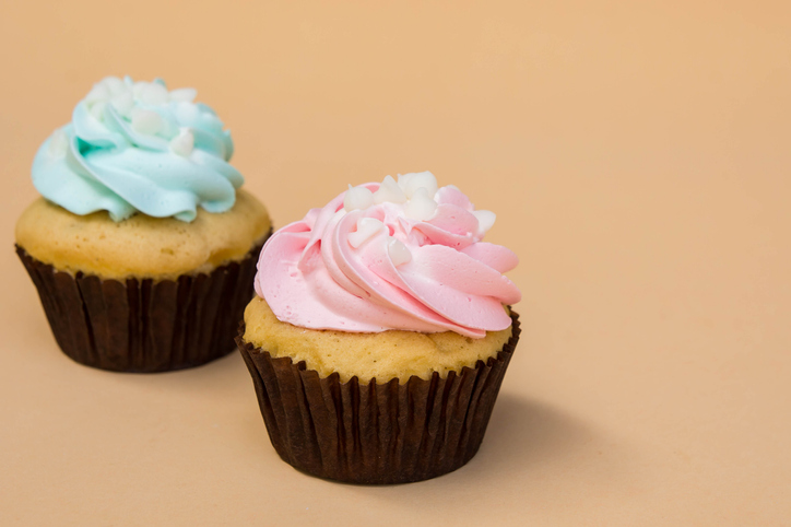 Close-Up Of Cupcakes Against Colored Background