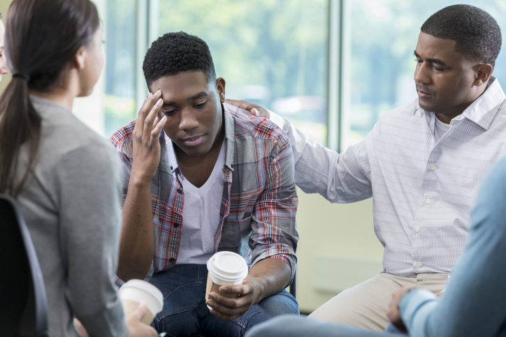 Upset man discusses issues during therapy session