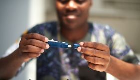 African American male using a glucose tester