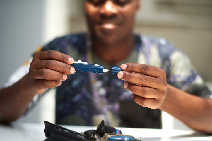 African American male using a glucose tester