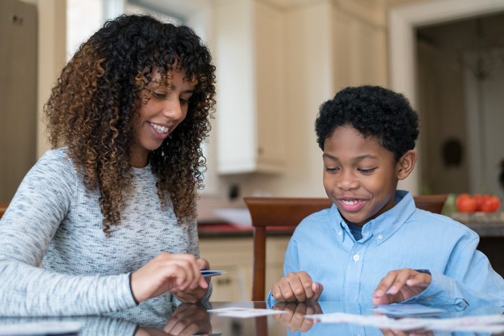 Mother and Son of African Descent Working on Homework Together