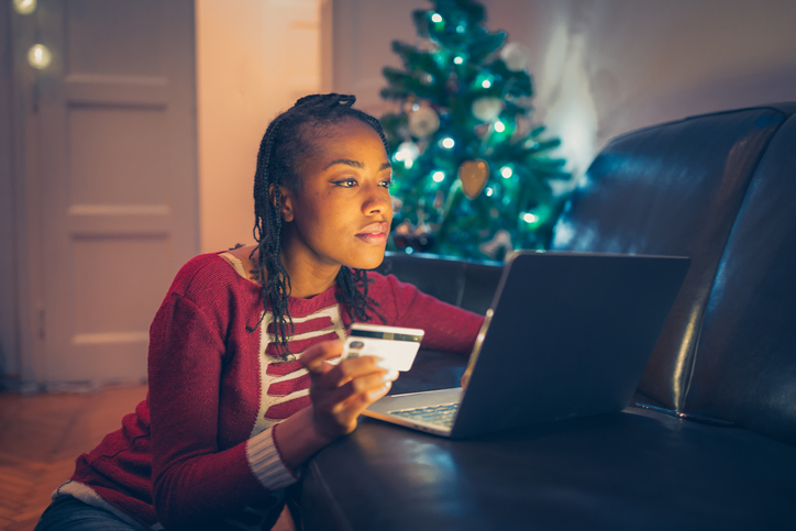 African American woman online Christmas shopping at home