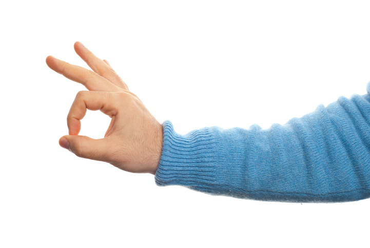 Close-Up Of Hand Gesturing Against White Background