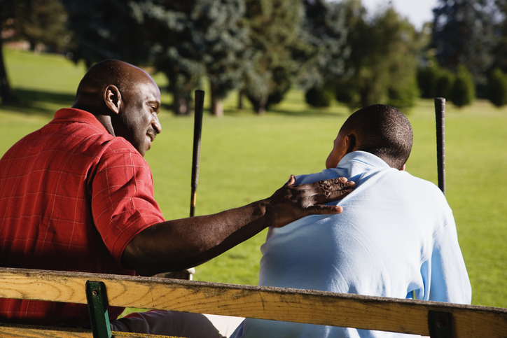 Father and Son on Bench at Golf Course