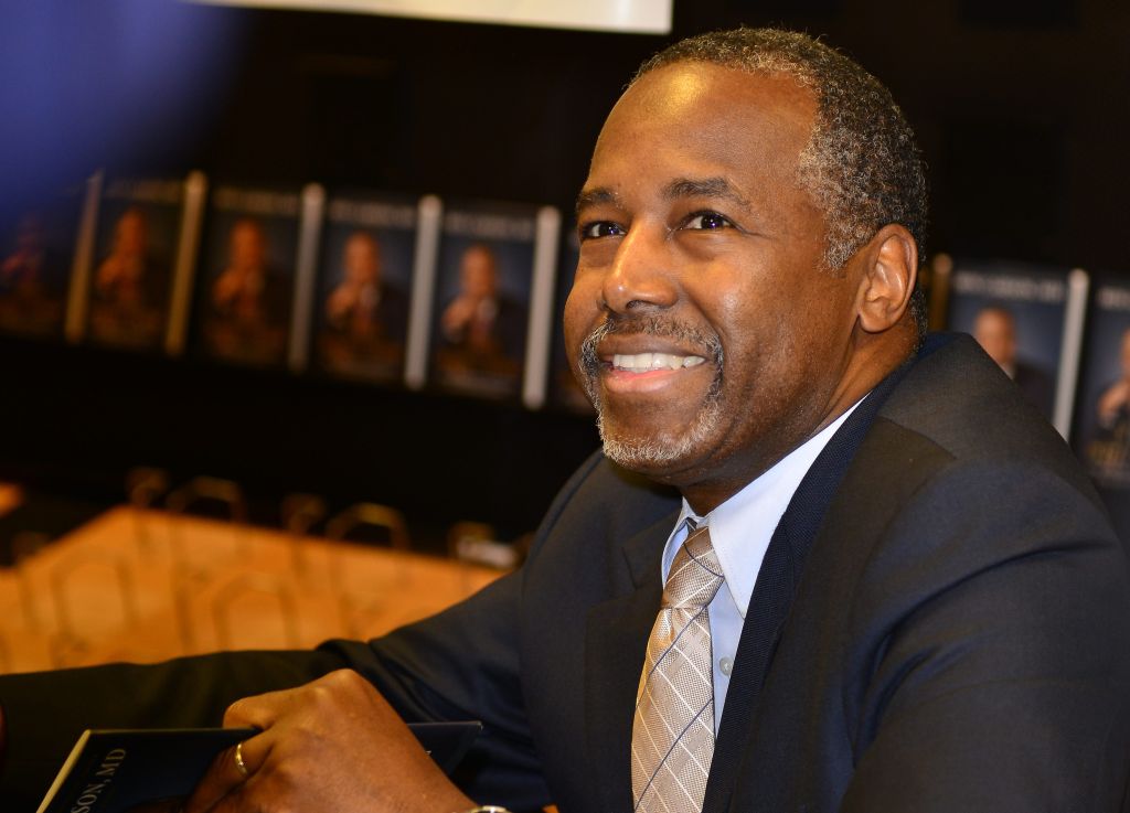 Photo Shows Ben Carson Standing So MAGA Men Can Sit On Rosa Parks' Birthday
