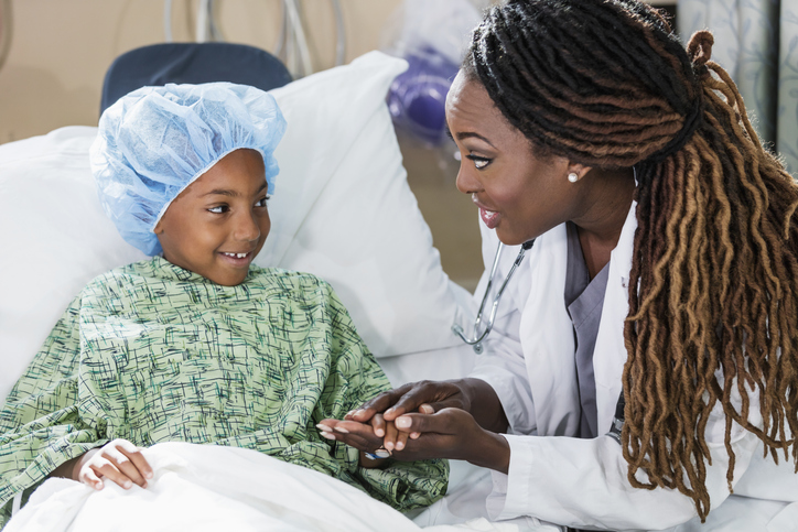Doctor in hospital talking to child patient