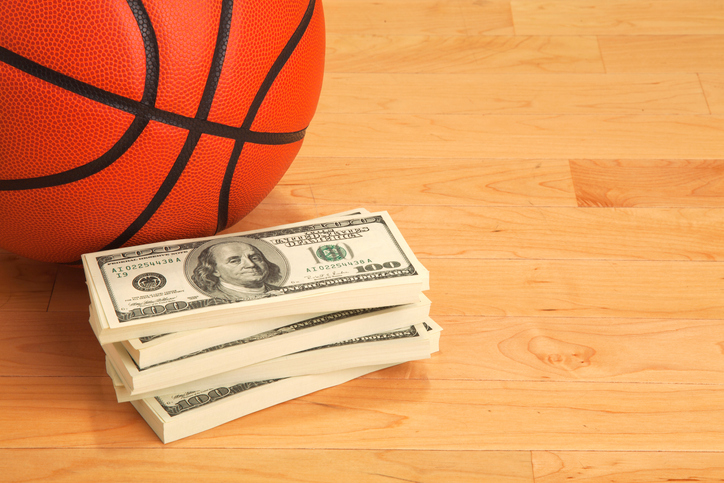 High Angle View Of Basketball By Us Currency On Hardwood Floor