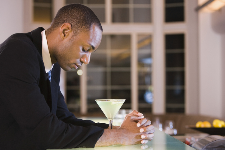 Side profile of a businessman with a glass of martini