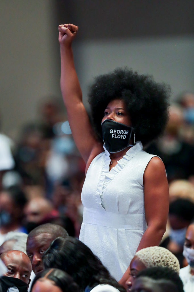 Family members stand up and react as the Rev. Al Sharpton gives the eulogy during the funeral for George Floyd