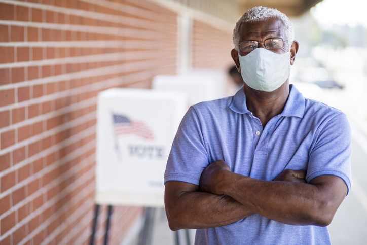 Senior Black Man Voting with a Mask