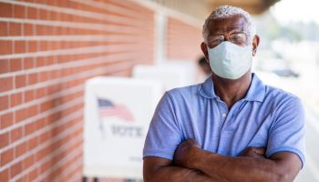 Senior Black Man Voting with a Mask