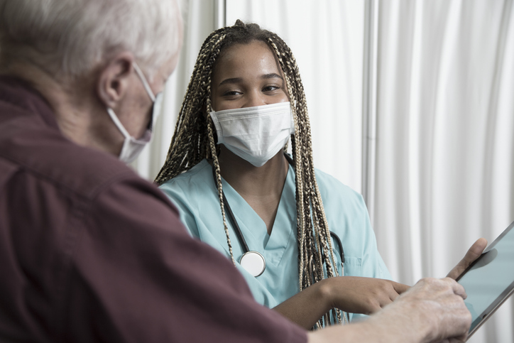 African descent doctor consults with Senior Caucasian patient.