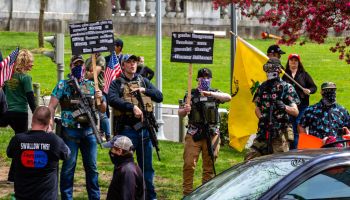 Armed protesters stand in front of the Pennsylvania State...