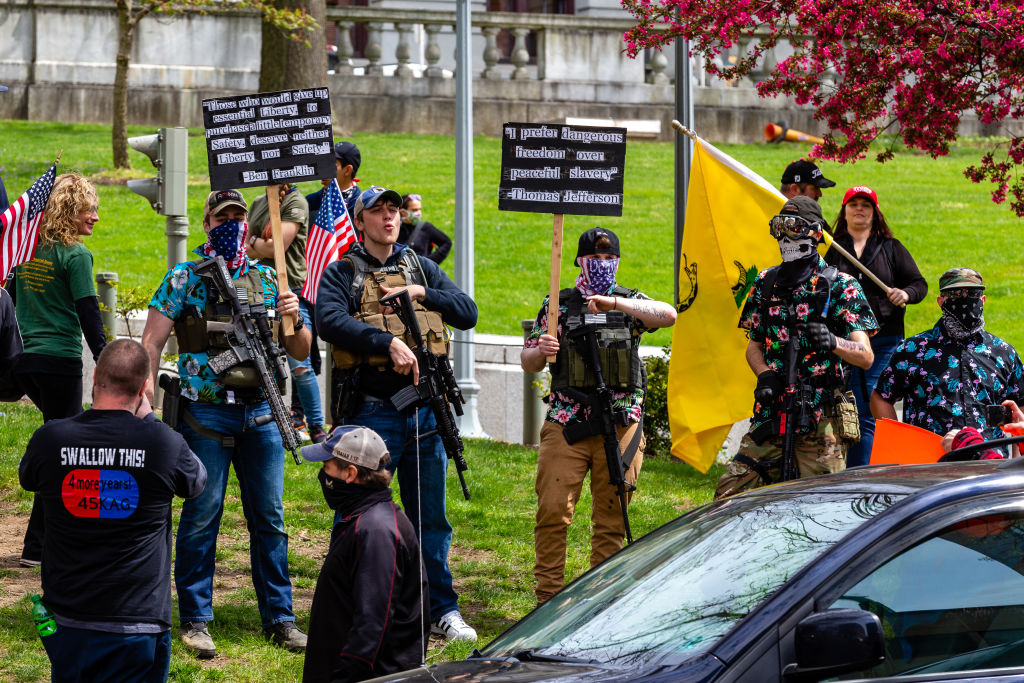 Armed protesters stand in front of the Pennsylvania State...