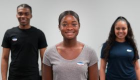 Smiling young adults wear "I voted" stickers