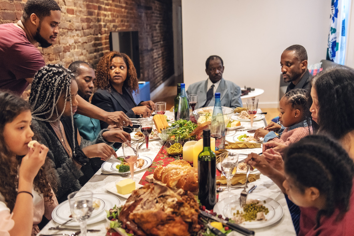 Multi-generation ethnic family having Thanksgiving dinner