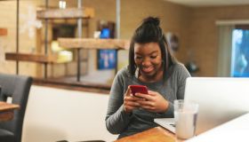 African American Generation Z Female Getting News on College Funding at Home