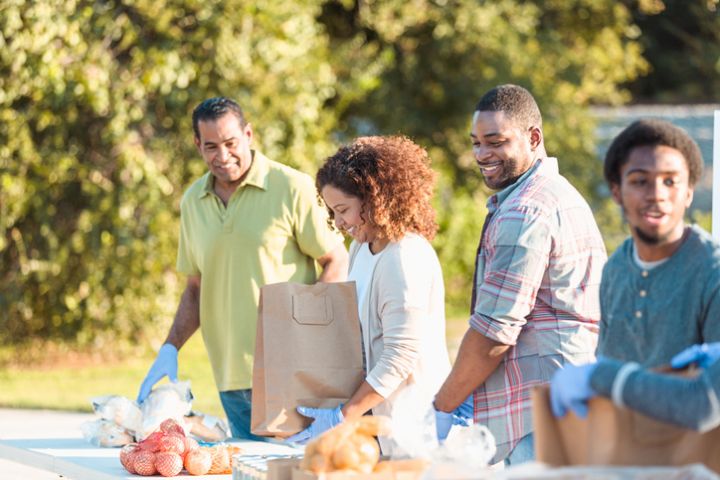 Cheerful people volunteer during food drive