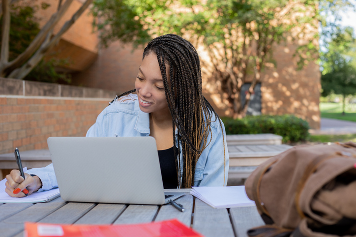 Adult woman working outdoors at picnic table