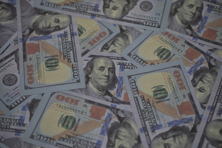 Lots of US Dollar bank notes as for financial business background.