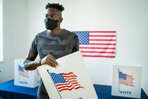 Young afro-American volunteer preparing the voting booths for Election Day