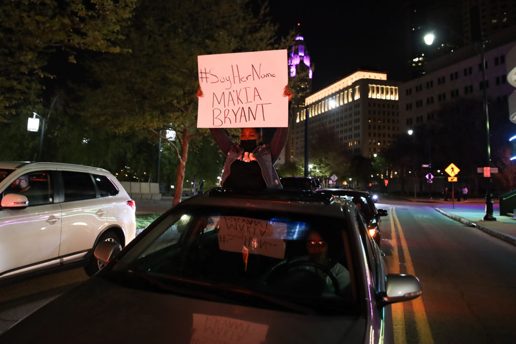 A protester holds a sign out of a car during the MaKhia...