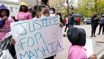 A child holds a placards that says Justice for MaKhia...