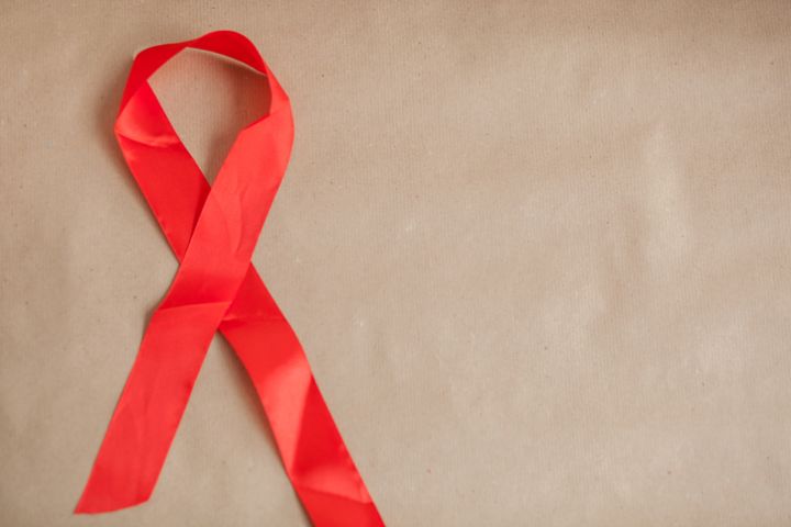 Close-Up Of Aids Awareness Ribbon On Paper