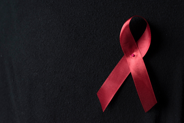 Close Up Of Aids Awareness Ribbon On Black Background