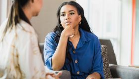Empathetic therapist listens to female client