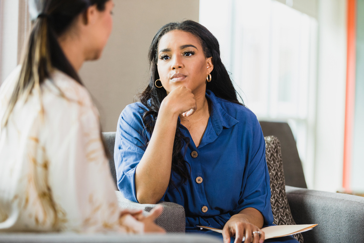 Empathetic therapist listens to female client