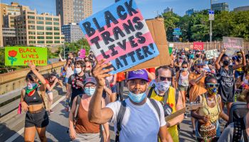 A Black Trans Lives Matter sign held by a participant at the...